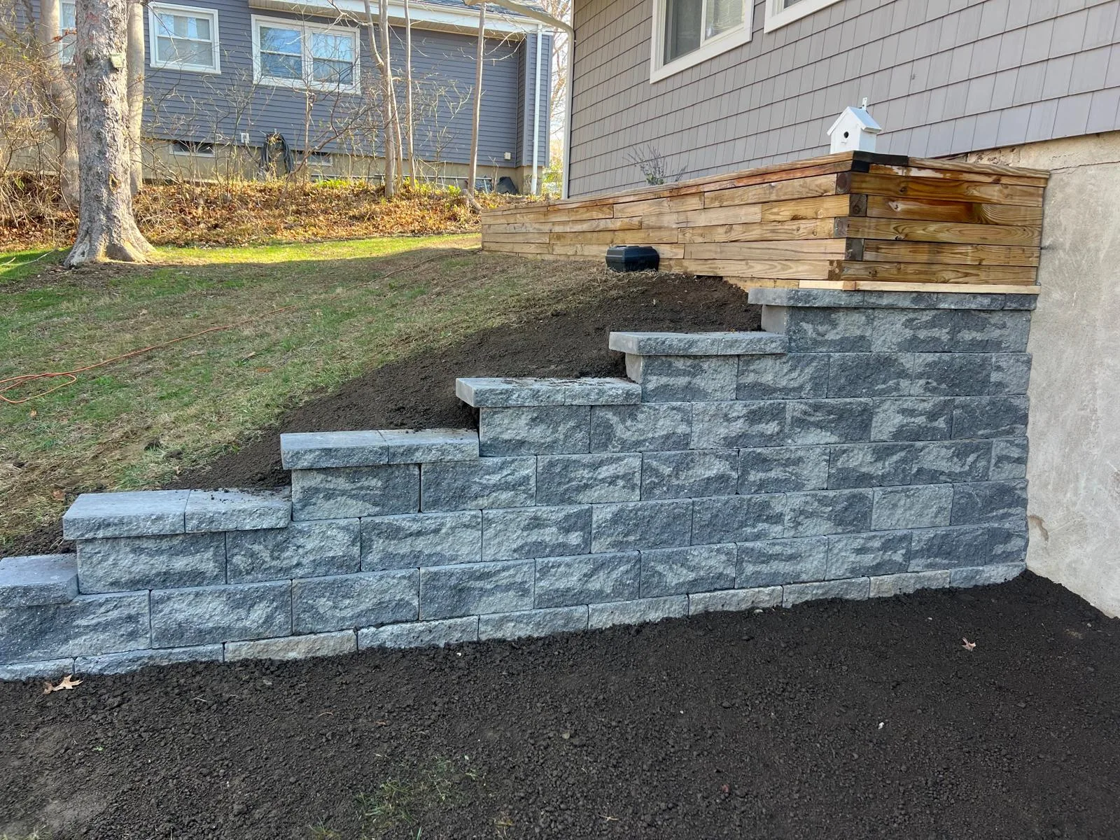 Completed tiered stone structure following a successful retaining wall installation Orange CT.
