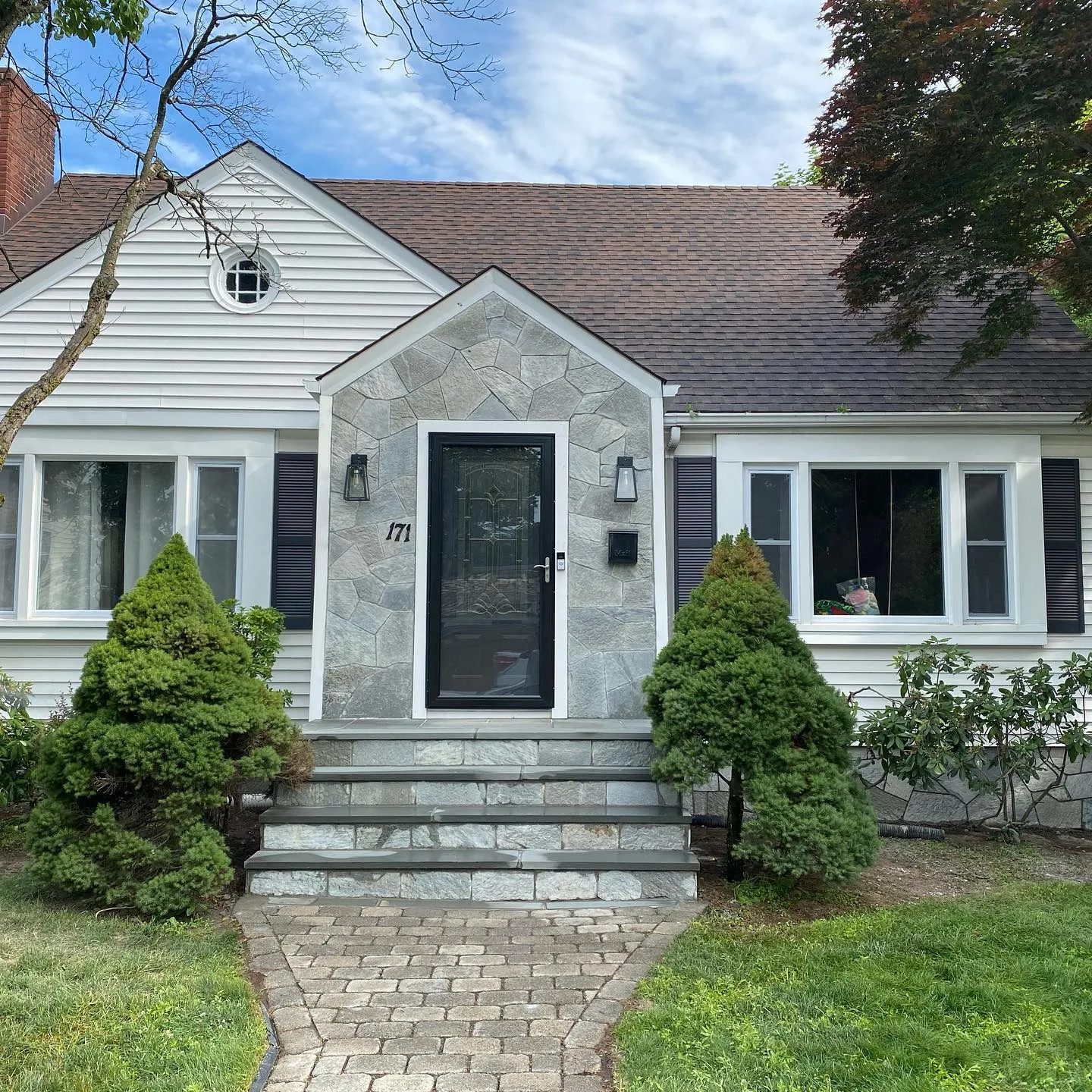 A completed Stone Veneer Entryway with blue-gray natural stone and matching masonry steps.